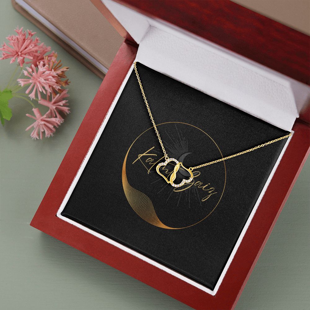 10K Yellow Gold Hearts Necklet A stunning, infinitely connected pair of 10K solid yellow gold hearts that perfectly symbolizes your Everlasting Love. Each heart is intricately accented with 18 pave set diamonds with a 0.07-carat weight, adding magnificent sparkle.
