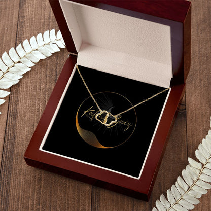 10K Yellow Gold Hearts Necklet A stunning, infinitely connected pair of 10K solid yellow gold hearts that perfectly symbolizes your Everlasting Love. Each heart is intricately accented with 18 pave set diamonds with a 0.07-carat weight, adding magnificent sparkle.